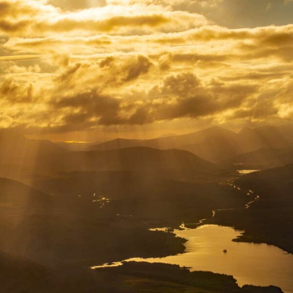 Sun Shining Through Dark Clouds In The Sky